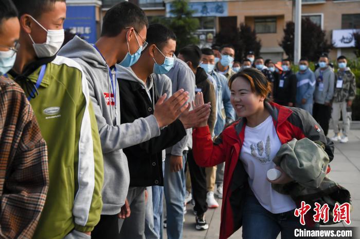 7月7日，拉薩三高考點外，領(lǐng)隊老師與考生擊掌鼓勁加油?！『闻罾?攝